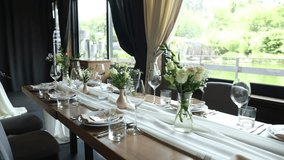 a beautiful wedding table with decor of flowers food and drinks for an banquet in the restaurant	