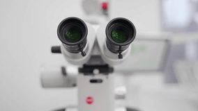 Close-up shot of microscope eyepiece tube in modern medical research laboratory. Modern equipment for scientists work in the genetics lab, biotechnology. Dental microscope in stomatology clinic. - Powered by Shutterstock - Get 15% off with code: PIKWIZARD15