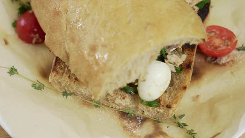 Fresh panini sandwich with tuna and quail eggs