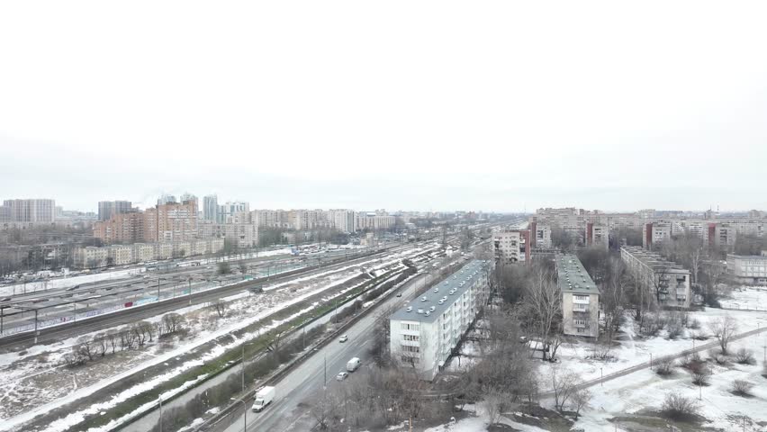 From the height of the snowy city of St. Petersburg, cars are driving and people are walking Royalty-Free Stock Footage #3472323623
