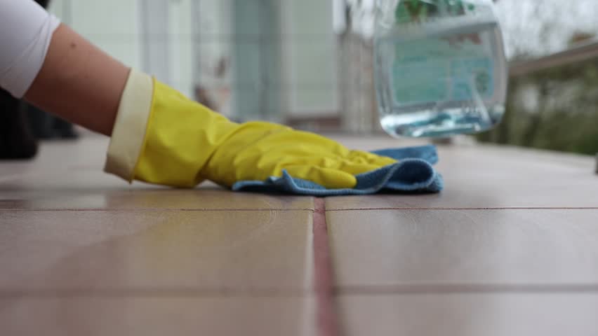Woman cleaning tile floors outdoors, spring cleaning, 4k footage, home cleaning