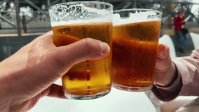 Friends toast beer glasses and drink. Clinking glasses outdoor. Couple at the bar celebrating weekend. - Powered by Shutterstock - Get 15% off with code: PIKWIZARD15