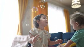 baby group playing bubbles indoors. happy family kid dream concept. baby group catching soap bubbles with their hands. group of children playing with soap bubbles having fun - Powered by Shutterstock - Get 15% off with code: PIKWIZARD15