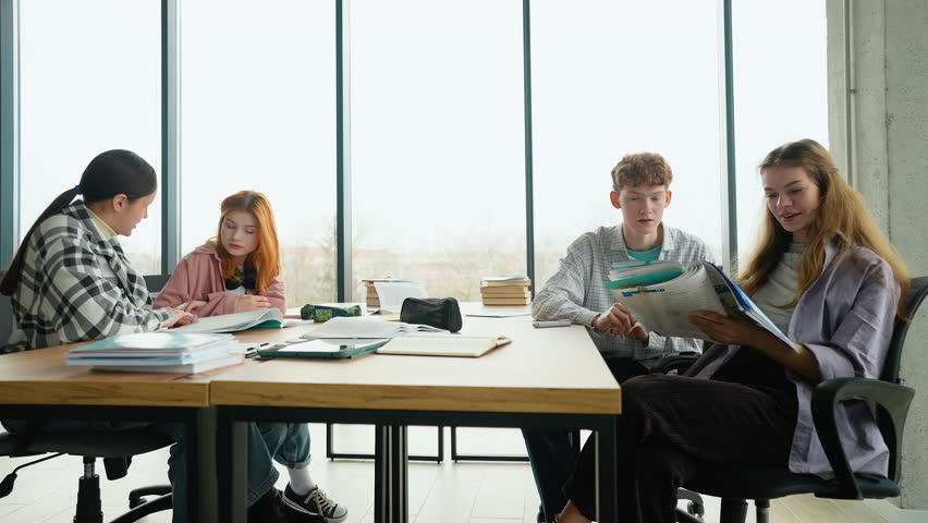 High school or college students studying and reading together in library education concepts