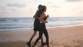 Back view of happy asian sports couple running at seashore with dramatic sky and bright sunset. Silhouette of man and woman jogger during outdoor activity on beach. 4k resolution and slow motion shot. - Powered by Shutterstock - Get 15% off with code: PIKWIZARD15