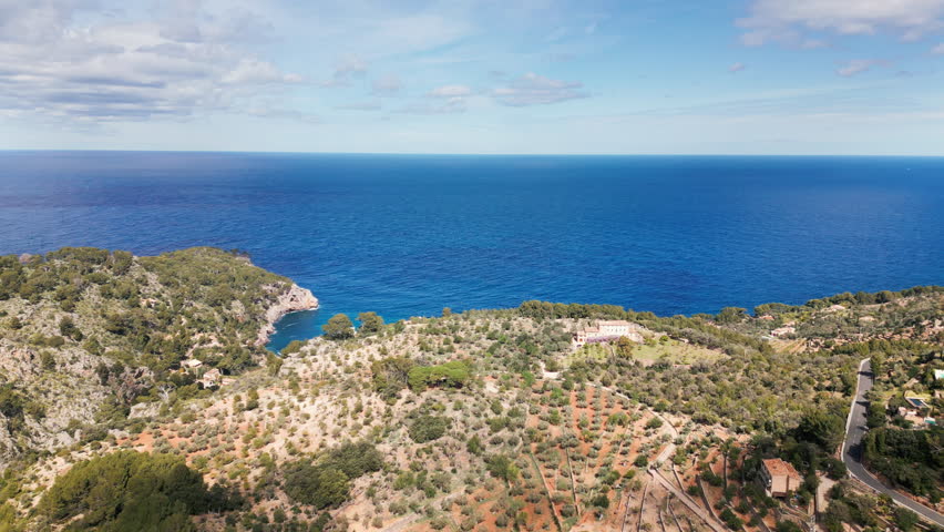 Aerial view of Mallorca coastline with clear blue sea and Mediterranean landscape.