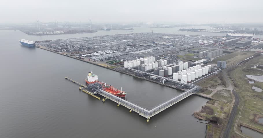 Aerial drone view on petrochemical containers and ship, transportation of gas and liquid energy over water. Maritime transport. Port of Antwerp, Belgium.