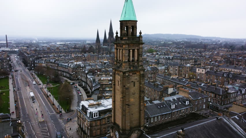 Drone shot overlooking the cityscape of Edinburgh, gloomy day in Scotland