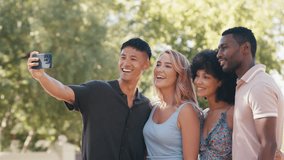 Multi-racial couple or friends outside in beautiful countryside taking group selfie on mobile phone laughing and smiling at camera - shot in slow motion - Powered by Shutterstock - Get 15% off with code: PIKWIZARD15