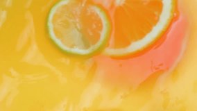 Slow motion video of mixing lemonade with fresh lemons, oranges and grapefruits