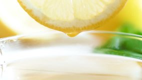 Macro 4k footage of juice droplet fallinjg from frsh lemon slice in jar