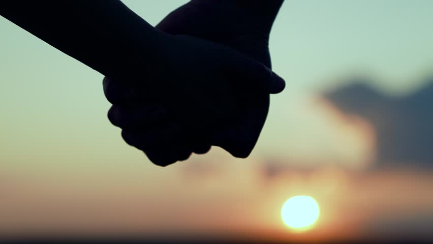 Separation, separation, quarrel. Separation of hands of man of woman. Family at sunset. Pair of man, woman separate their hands in front of sun. Closeup of guy lets go of girls hand, separation. Royalty-Free Stock Footage #3472721083