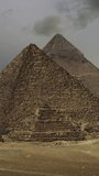 Timelapse with sunset clouds over great pyramids at Giza Cairo in Egypt. Vertical video