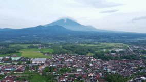 Aerial view of beautiful countryside with mountain view on the background. Indonesia.