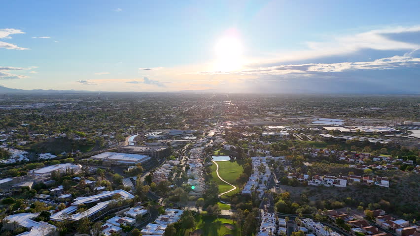 Panoramic aerial of Northern Phoenix, Scotsdale homes with Camelback and other mountain ranges in background.