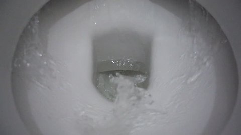 Slow motion shot of water being flushed in a toilet bowl, 250 fps. Toilet bowl with running water. flickering video
