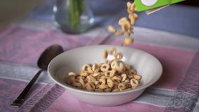 Super Slow Motion of Breakfast Cereals Falling into Bowl in 4K Video