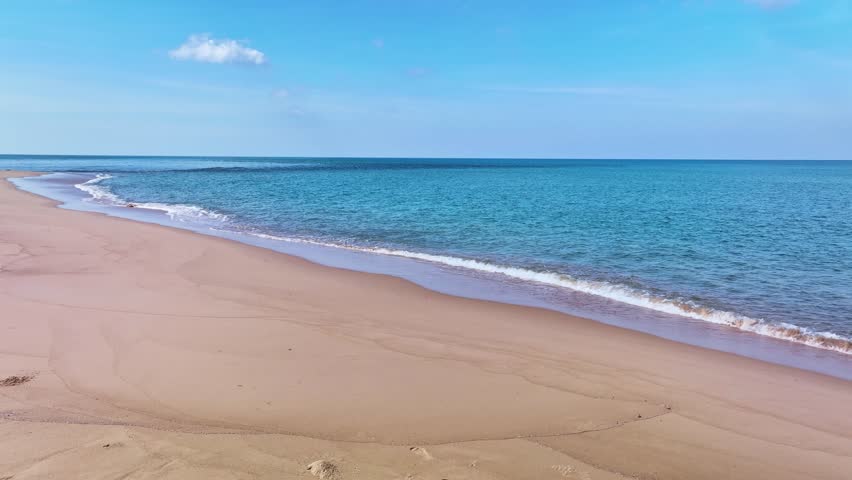 Beautiful sea summer landscape,Waves sea water surface High quality video Bird's eye view,Drone top view waves crashing on sand beach,Nature ocean sea beach background