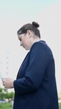 Vertical video 360 degrees. Caucasian business woman talking on video link outdoors.