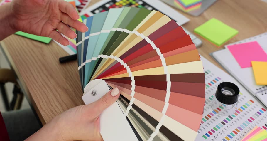 Woman hand holds palette of samples of colors and shades. Interior designer job