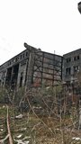 Old industrial building for demolition. large ruined abandoned factory hangar or warehouse. Vertical video