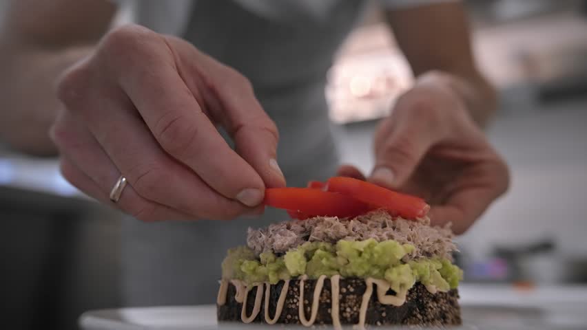 Male head chef prepare tasty fresh bruschetta dish close up. Man cook meal restaurant kitchen. Young adult person work cafe cuisine. Guy make diet lunch food. Culinary worker job. Cookery staff recipe
