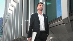 Handsome 30s top manager walking in formal suit. Successful entrepreneur stroll urban city street. Confident serious business man. Young male businessman. 40s employee job. Office work. CEO boss gait. - Powered by Shutterstock - Get 15% off with code: PIKWIZARD15