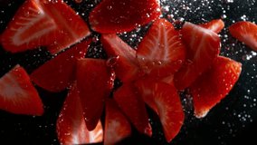 Super Slow Motion Shot of Strawberry Cuts Falling and Flowing in Water Isolated on Black at 1000 fps - Powered by Shutterstock - Get 15% off with code: PIKWIZARD15