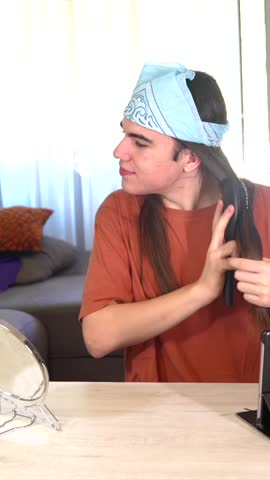 a gay person making up at home next to a rainbow lgbt flag