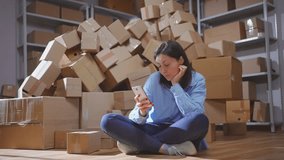 a piles of cardboard boxes female scans the QR code with the phone - Powered by Shutterstock - Get 15% off with code: PIKWIZARD15
