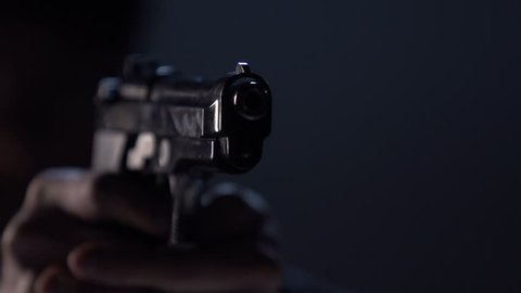 Close up of 9 mm handgun. Shooter takes three shots