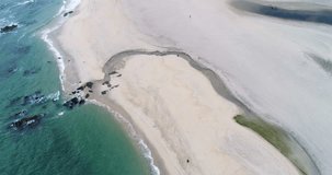 shore of a beach and a person walking, aerial video with drone.