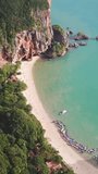Aerial view of tropical turquoise lagoon, Pranang beach between rocks, Krabi, Railay, Thailand. Vertical video