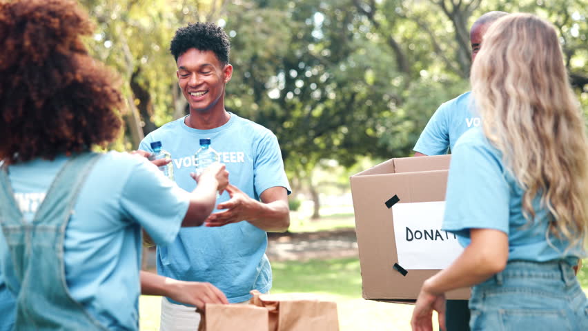 Teamwork, donation and volunteering people at a park with water, collection or community service. NGO, support and student friends celebrating earth day with charity, help or aid for poverty relief - Powered by Shutterstock - Get 15% off with code: PIKWIZARD15