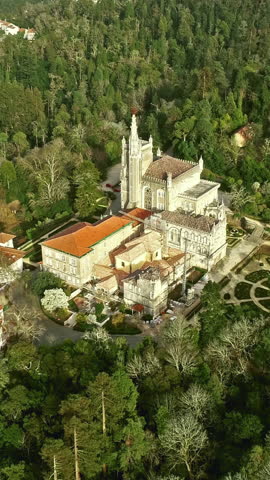 Aerial around view of the park and palace of Bussaco, Coimbra, Portugal. Vertical video