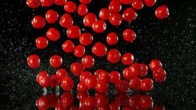 Super Slow Motion of Falling Cherry Tomatoes into Water. Isolated on Black Background. Filmed on High Speed Cinema Camera, 1000 fps. - Powered by Shutterstock - Get 15% off with code: PIKWIZARD15