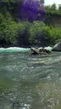 Mountain River Canyon with People in Rafting Boat. Whitewater Rafting Team Descending Raging Rapids. Picturesque Canyon with Mountains, Forest and Mountain River. Active Vacations.