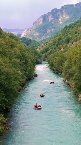 White Water Rafting Drone Point of View. People White Water Rafting on Mountain River. Active Vacations. Picturesque Canyon with High Mountains, Forest and Three Whitewater Rafts on Mountain River. Royalty-Free Stock Footage #3473247709