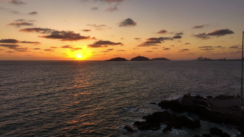 Aerial tracking shot of serene sunset on the coast of Mazatlan, Sinaloa, Mexico
