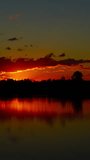 Landscape with sunrise over lake, timelapse. Vertical video