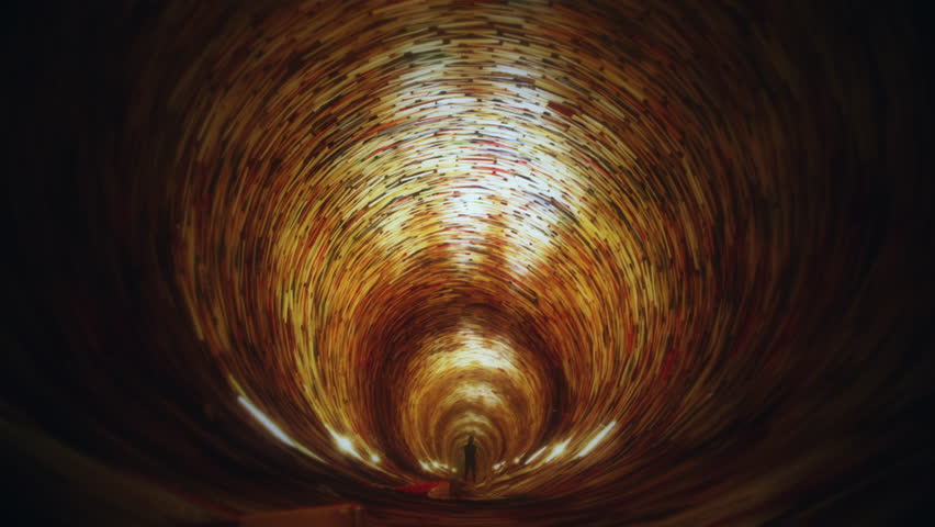 Male Silhouette Books Tunnel Flickering Lights Tracking Shot. Silhouette of a man standing inside a tunnel of books with flickering lights. Tracking shot