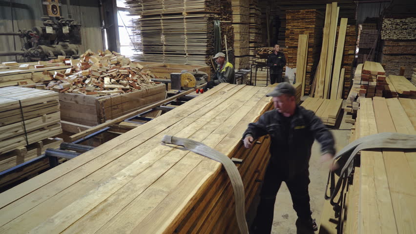 Moving Ropes From Bunch Of Pine Boards At Storage Facility At Production Plant. Working Process In Storage Room. Pine Boards For Storage. Manufacturing Of Pine Boards. Workpieces. Lumber Industry. Royalty-Free Stock Footage #3473501447