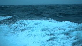 Storm ay sea. Side view from ship low on water. High waves and splashes. Wind breaks waves. White foam on wind. - Powered by Shutterstock - Get 15% off with code: PIKWIZARD15