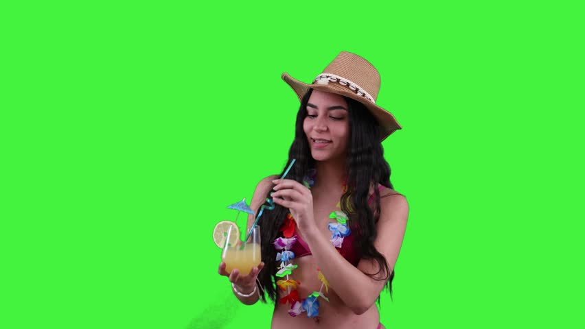 Young hispanic woman enjoying a refreshing summer cocktail on the beach, wearing a stylish bikini and a beach hat. Sunny day vibes and tropical relaxation concept on a Green Screen, Chroma Key