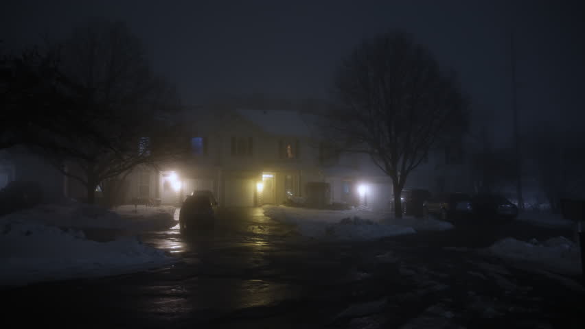 Wide footage of Dark street and silhouette of a house at night with heavy fog