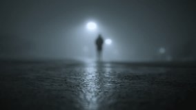 The silhouette of man walking on empty parking lot at fogy night time - Powered by Shutterstock - Get 15% off with code: PIKWIZARD15