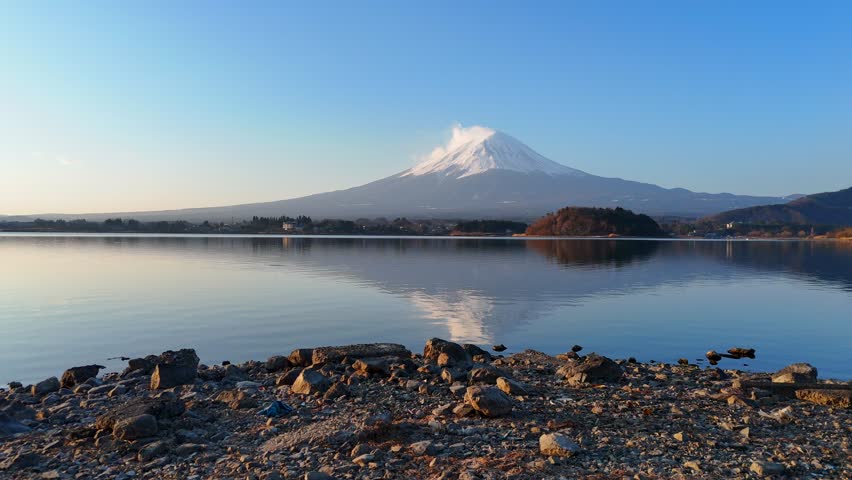 Japan’s Mt. Fuji is an active volcano about 100 kilometers southwest of Tokyo. Commonly called Fuji-san, it’s the country’s tallest peak, at 3,776 meters.	 Royalty-Free Stock Footage #3473621223