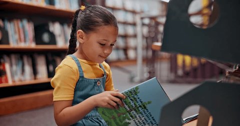 Reading book, child or girl in a library for a story in school campus for education on bookshelf. Smile, learning or smart kid student with scholarship studying knowledge, research or information Stockvideo