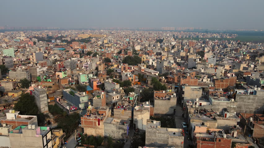 A drone shot of a densely populated neighborhood in Delhi, India's capital, showing the smog and pollution that plagues Indian cities.