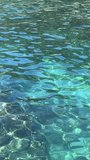 Amazing clear sea water blue surface, vertical video. 